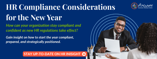 A professional setting with a person holding papers, discussing HR compliance considerations for the upcoming year.